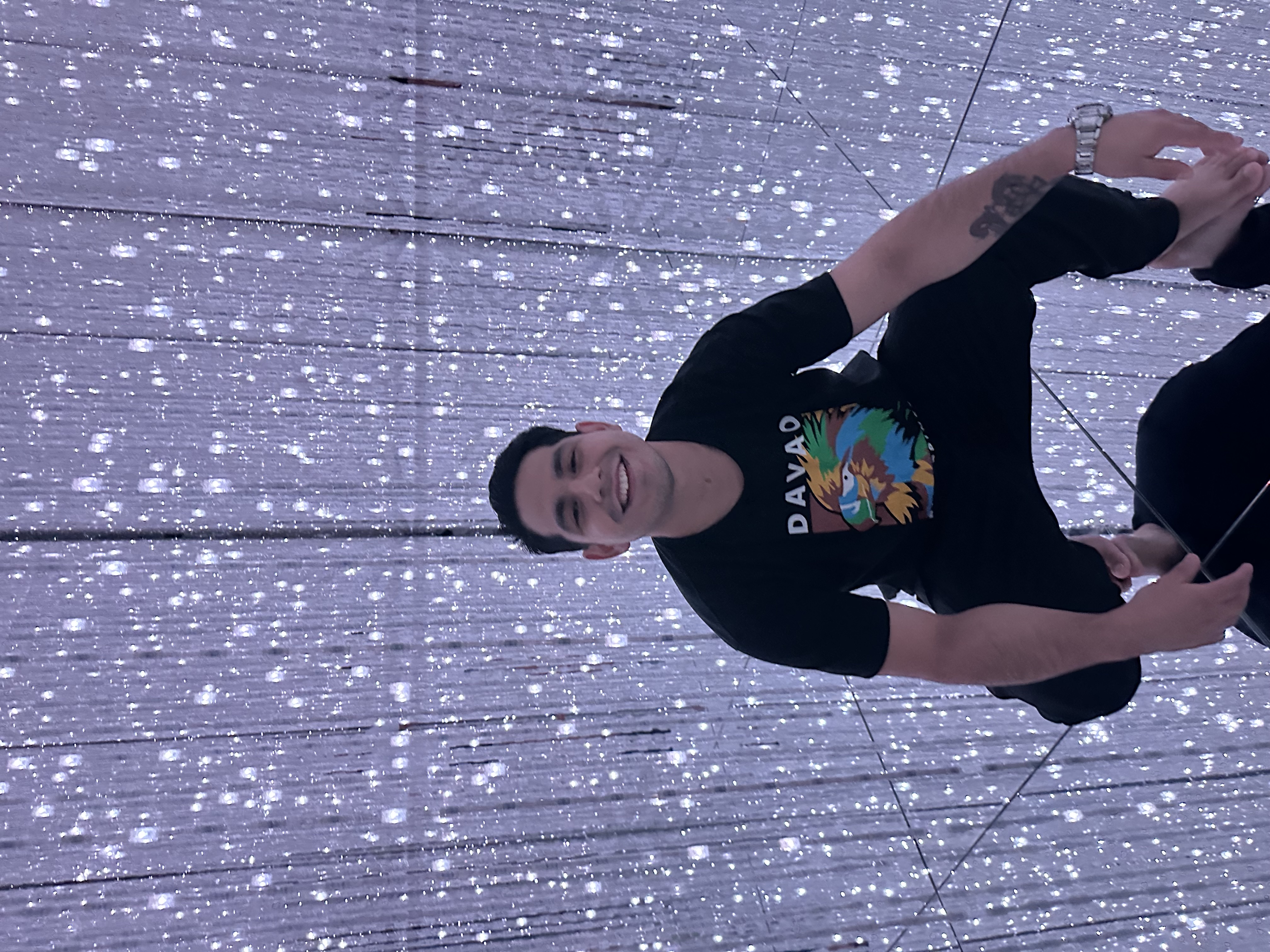 Eric smiling among shimmering hanging lights