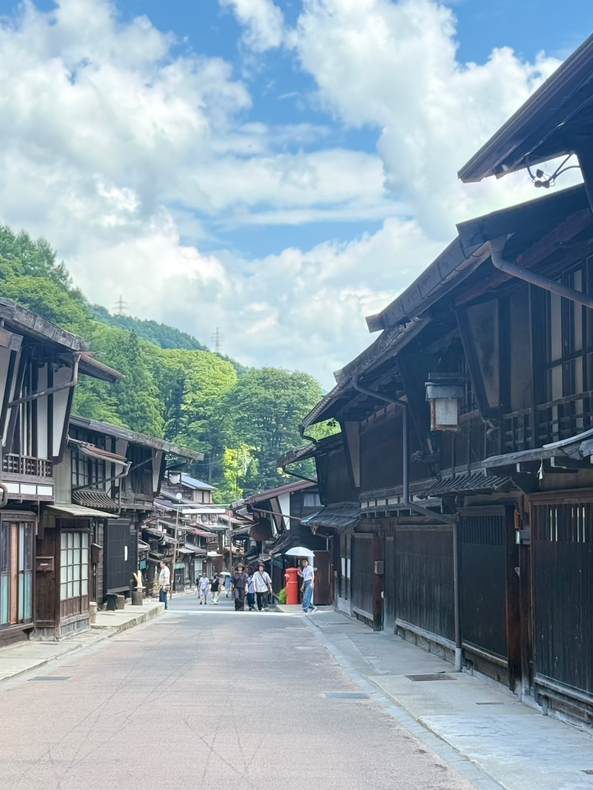 Traditional wooden buildings lining a quiet Japanese street